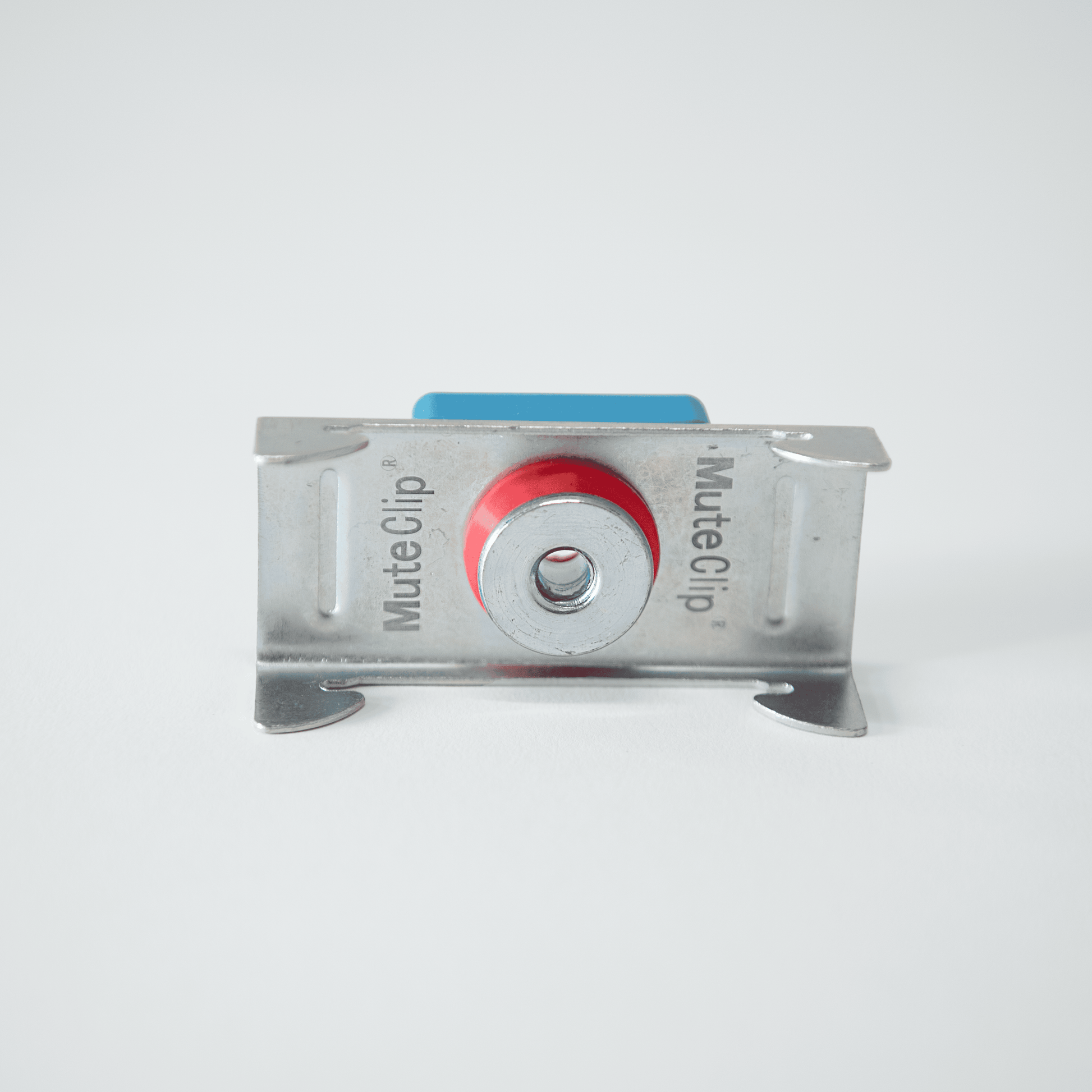 Metallic mute clip with red button on a white background