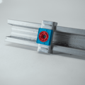 Metal bracket with red and blue components on a white background