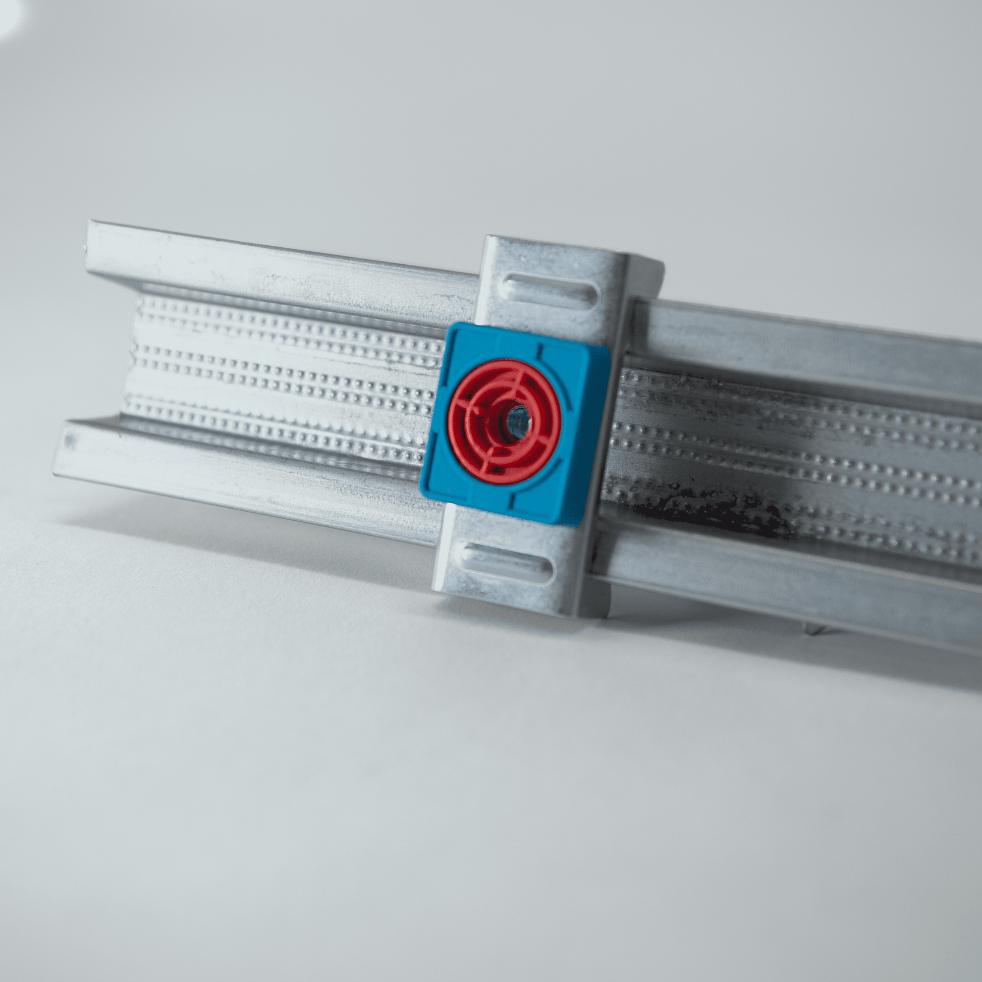 Metal bracket with red and blue components on a white background