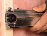 Black acoustic insulation clip being fitted