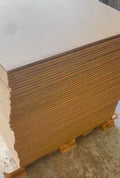 Stack of cardboard boxes on a pallet with a white surface above